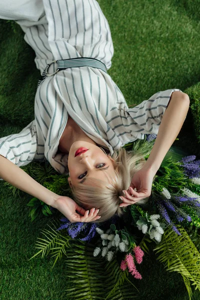 Top View Beautiful Stylish Girl Lying Artificial Grass Fern Flowers — Stock Photo, Image