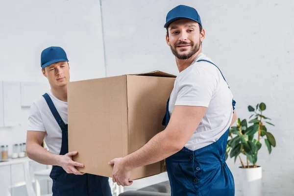 Two Handsome Movers Transporting Cardboard Box Apartment — Stock Photo, Image