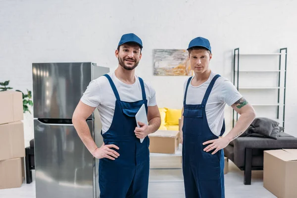 Two Handsome Movers Digital Tablet Looking Camera Apartment — Stock Photo, Image