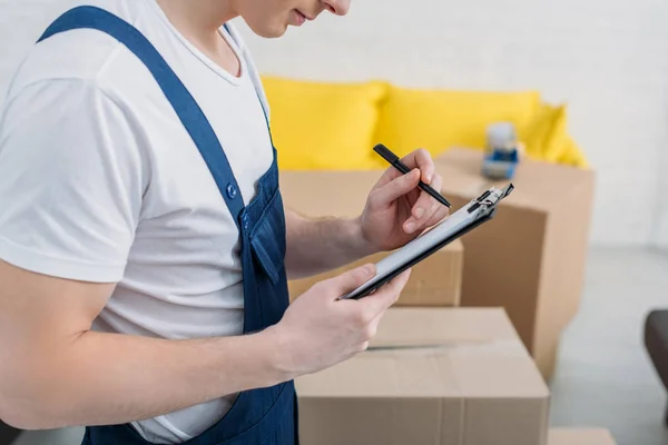 Cropped View Mover Writing Clipboard Cardboard Boxes Apartment — Stock Photo, Image