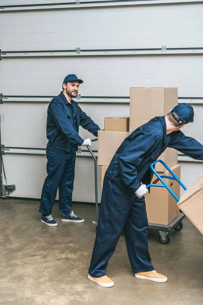 Dos Transportistas Uniformes Que Utilizan Camiones Mano Mientras Transportan Cajas — Foto de Stock