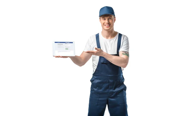 Handsome Smiling Mover Gesturing Hand While Presenting Digital Tablet Facebook — Stock Photo, Image
