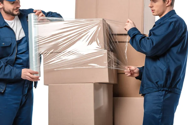 Two Movers Wrapping Cardboard Boxes Roll Stretch Film Isolated White — Stock Photo, Image