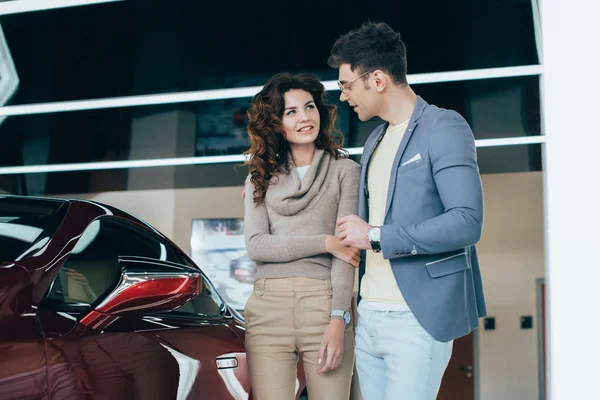 Happy Man Looking Curly Girl While Standing Red Automobile — Stock Photo, Image