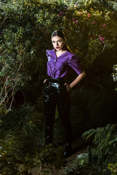 Elegant Young Woman Purple Blouse Standing Arms Akimbo Orangery — Stock Photo, Image