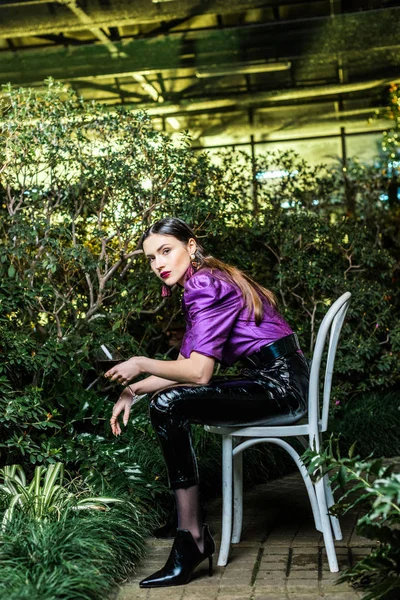 Attractive Woman Purple Blouse Leather Pants Sitting Chair Holding Wine — Stock Photo, Image