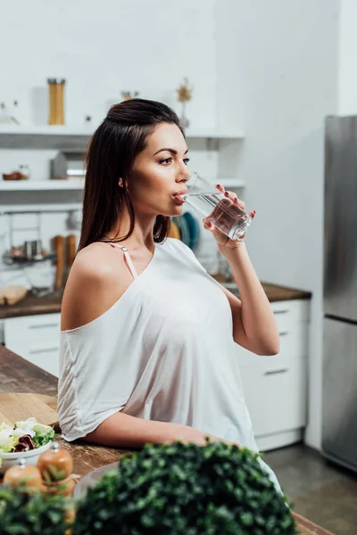 Mujer Atractiva Pensativo Beber Agua Cerca Mesa Cocina — Foto de Stock