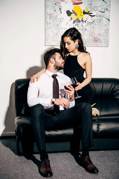 Bearded Man Looking Girl Black Dress While Sitting Sofa Holding — Stock Photo, Image