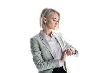 beautiful blonde businesswoman checking time on watch isolated on white clipart