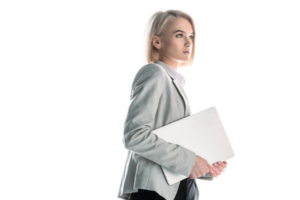 attractive, confident businesswoman holding laptop isolated on white