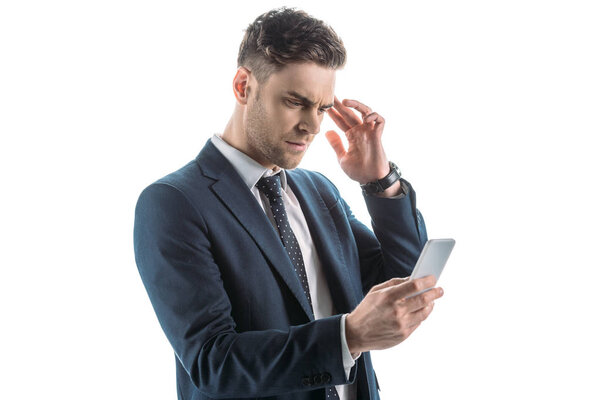 handsome, thoughtful businessman using smartphone isolated on white