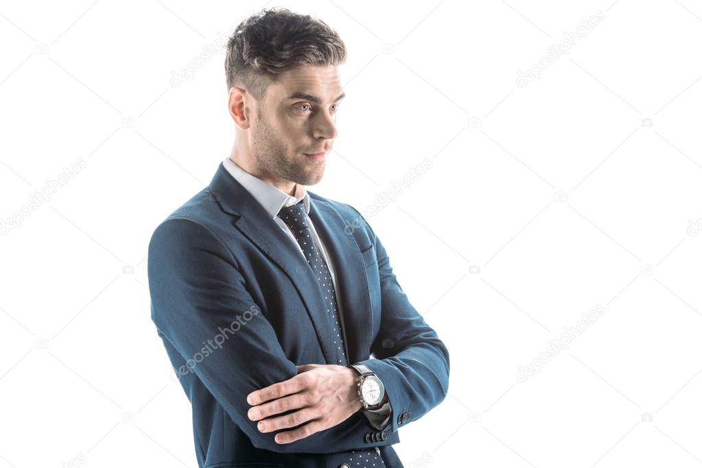 handsome, confident businessman with crossed arms looking away isolated on white