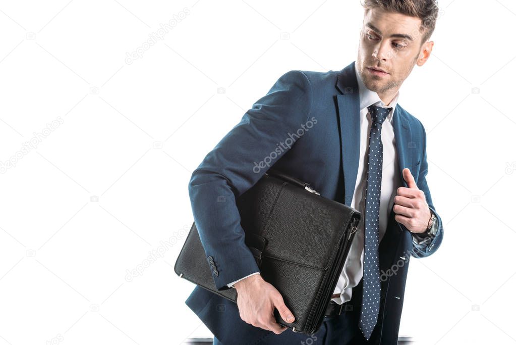 handsome, hurrying businessman holding briefcase isolated on white