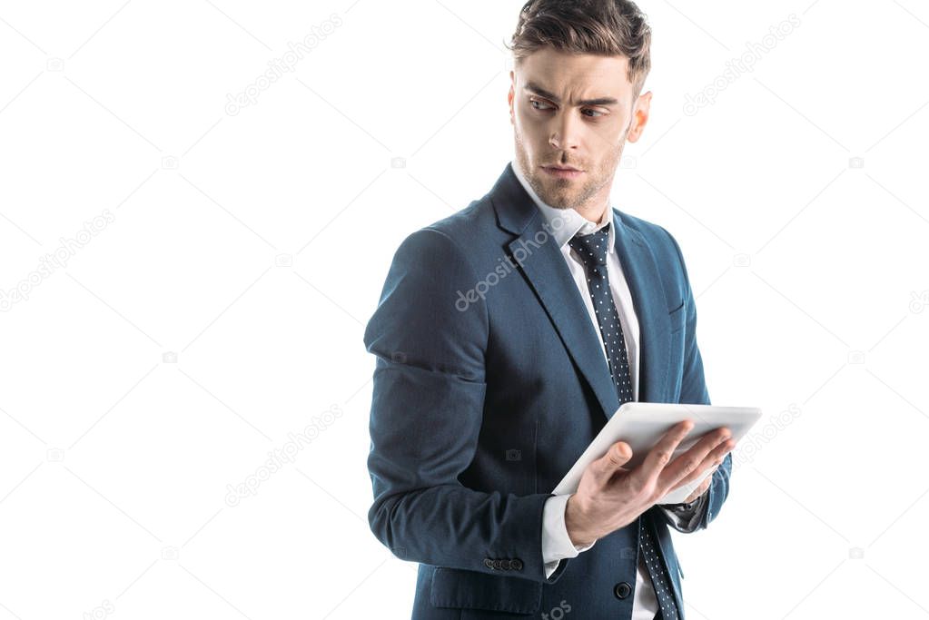 serious, thoughtful businessman using digital tablet isolated on white