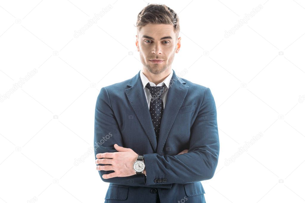 front view of handsome, confident businessman with crossed arms isolated on white