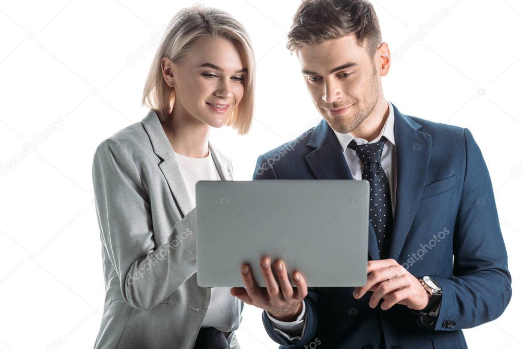 smiling businesswoman and cheerful businessman using digital laptop isolated on white