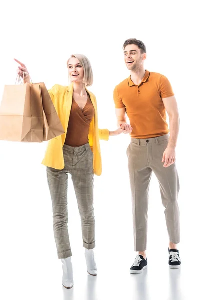 Pretty Smiling Woman Holding Paper Bags Pointing Finger While Standing — Stock Photo, Image