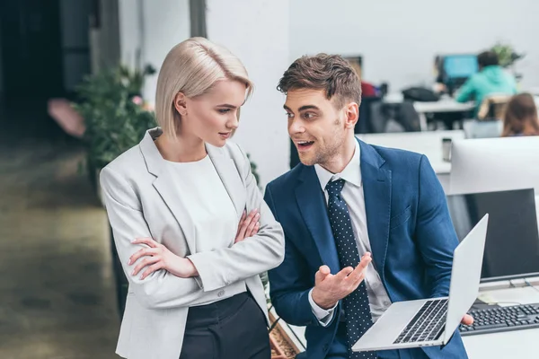 Two Young Business Partners Talking Using Laptop Together — Stock Photo, Image