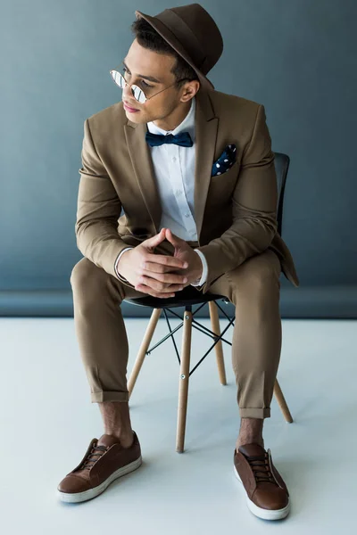 Stylish Mixed Race Man Suit Sunglasses Sitting Chair Posing Grey — Stock Photo, Image
