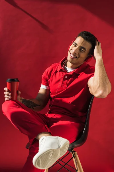 Stylish Mixed Race Man Headphones Sitting Holding Coffee Smiling Red — Stock Photo, Image