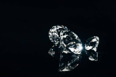 transparent pure diamonds isolated on black with reflection clipart
