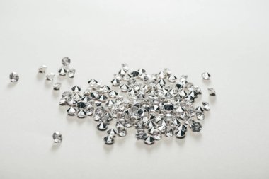 transparent pure small diamonds scattered on white background clipart