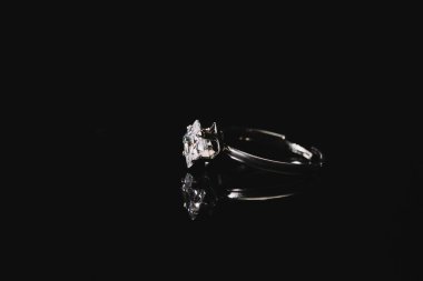 engagement ring with pure diamond isolated on black  clipart