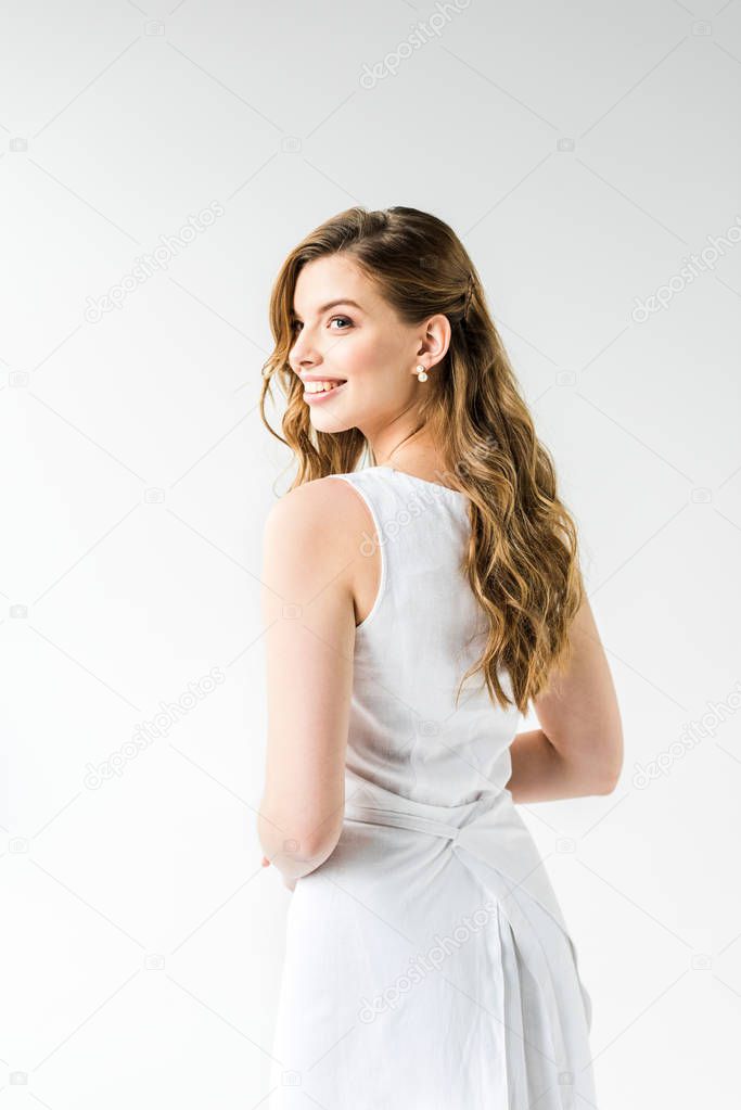 attractive happy girl in dress smiling on white