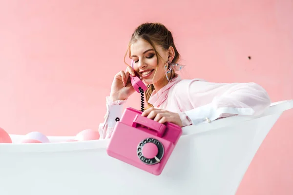 Cheerful Girl Talking Retro Phone While Lying Bathtub Pink — Stock Photo, Image