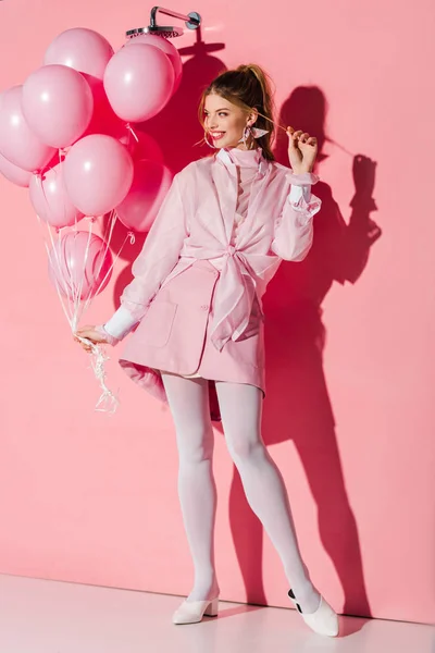 Cheerful Young Woman Holding Air Balloons While Touching Hair Pink — Stock Photo, Image