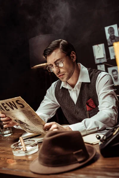 Concentrated Detective Glasses Reading Newspaper Dark Office — Stock Photo, Image