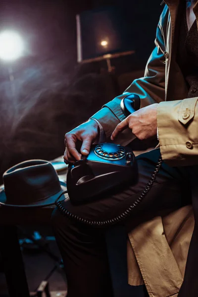 Partial View Man Trench Coat Using Telephone Dark Office — Stock Photo, Image