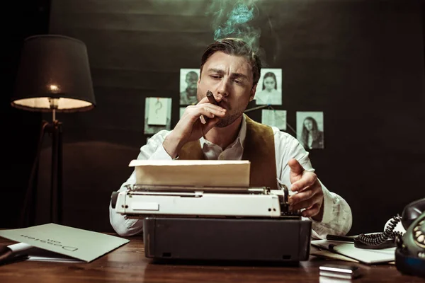 侦探抽雪茄和使用打字机在黑暗的办公室 — 图库照片