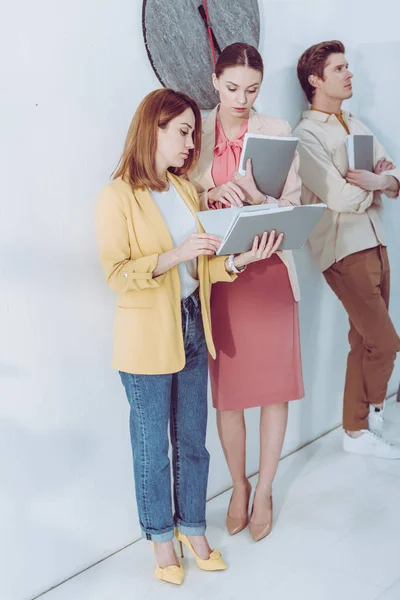 Mujeres Atractivas Mirando Carpeta Cerca Hombre Guapo Esperando Fila — Foto de Stock