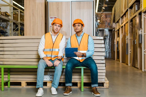 Concentrated Multicultural Workers Sitting Bench Warehouse — Stock Photo, Image