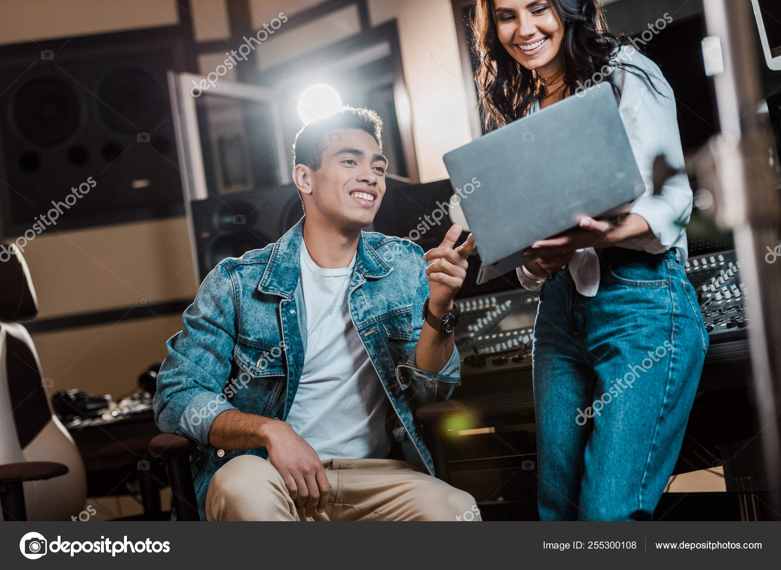 Smiling Multicultural Sound Producers Using Laptop Recording Studio