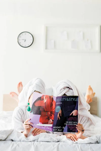 Barefoot Women Bathrobes Jewelry Towels Heads Hiding Magazine Together While — Stock Photo, Image