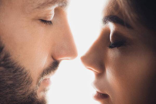 cropped view of couple with closed eyes isolated on white