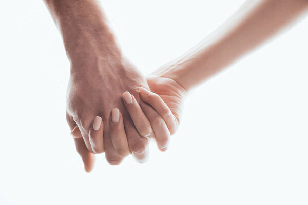 Partial view of man and woman holding hands isolated on white