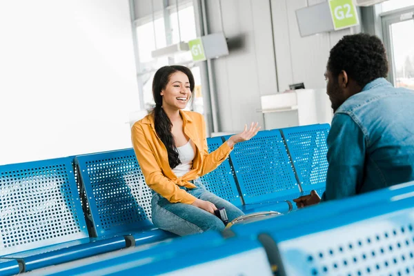 Happy African American Woman Laughing While Sitting Departure Lounge Boyfriend — Stock Photo, Image