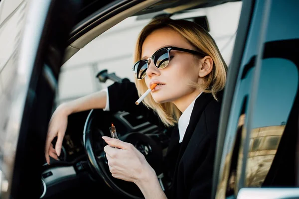 Mulher Loira Segurando Isqueiro Com Fogo Enquanto Fuma Cigarro Carro — Fotografia de Stock