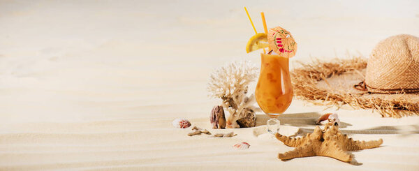 panoramic shot of cocktail, starfish, straw hat and sea stones on beach with copy space