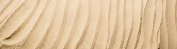 テクスチャ付き砂とコピースペースを持つ背景のパノラマショット — ストック写真