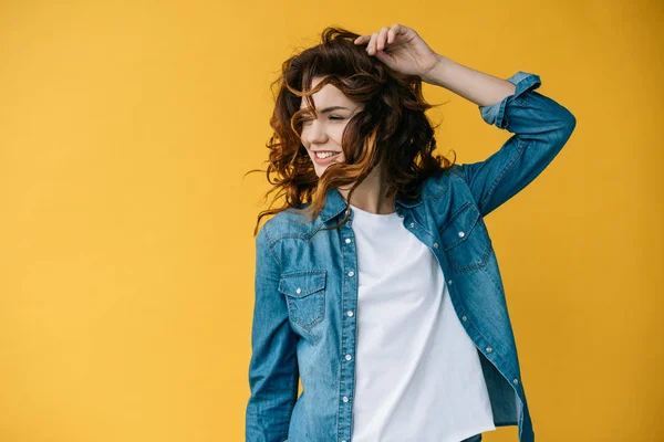 Cheerful Curly Young Woman Touching Hair Orange — Stock Photo, Image