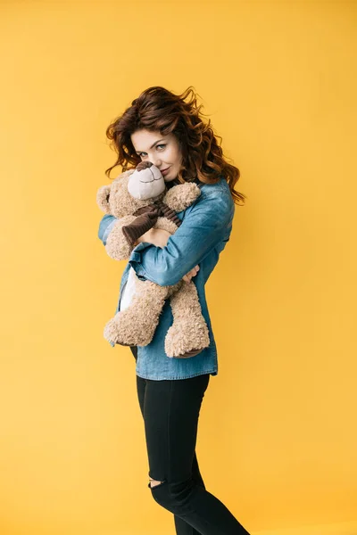 Young Woman Covering Face Teddy Bear Looking Camera Orange — Stock Photo, Image