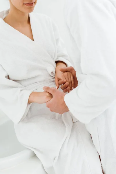 Vista Cortada Homem Mãos Dadas Com Jovem Mulher Roupão Banho — Fotografia de Stock