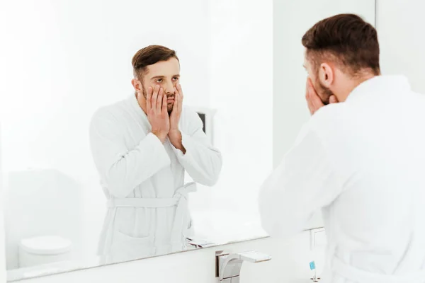 Selective Focus Upset Bearded Man Looking Mirror While Touching Face — Stock Photo, Image