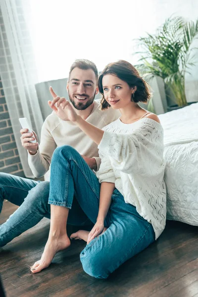 Attractive Brunette Woman Pointing Finger While Sitting Handsome Man Holding — Stock Photo, Image