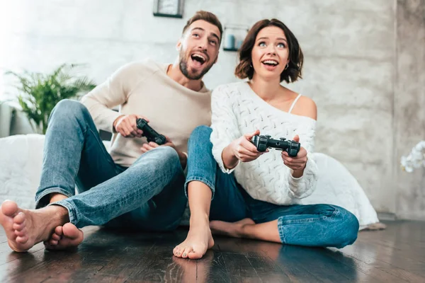低角度视图的快乐男人和女人在家里玩视频游戏 — 图库照片
