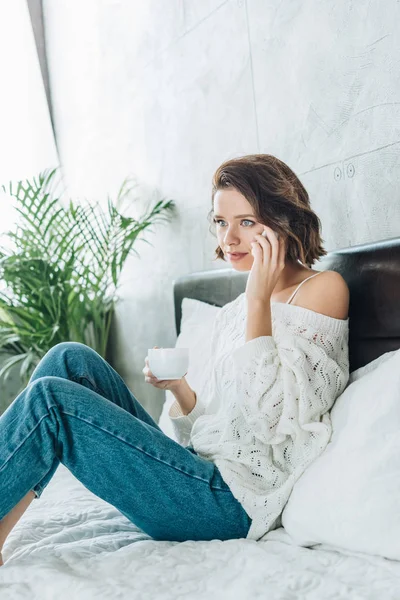Attractive Brunette Woman Holding Cup Talking Smartphone Bedroom — Stock Photo, Image